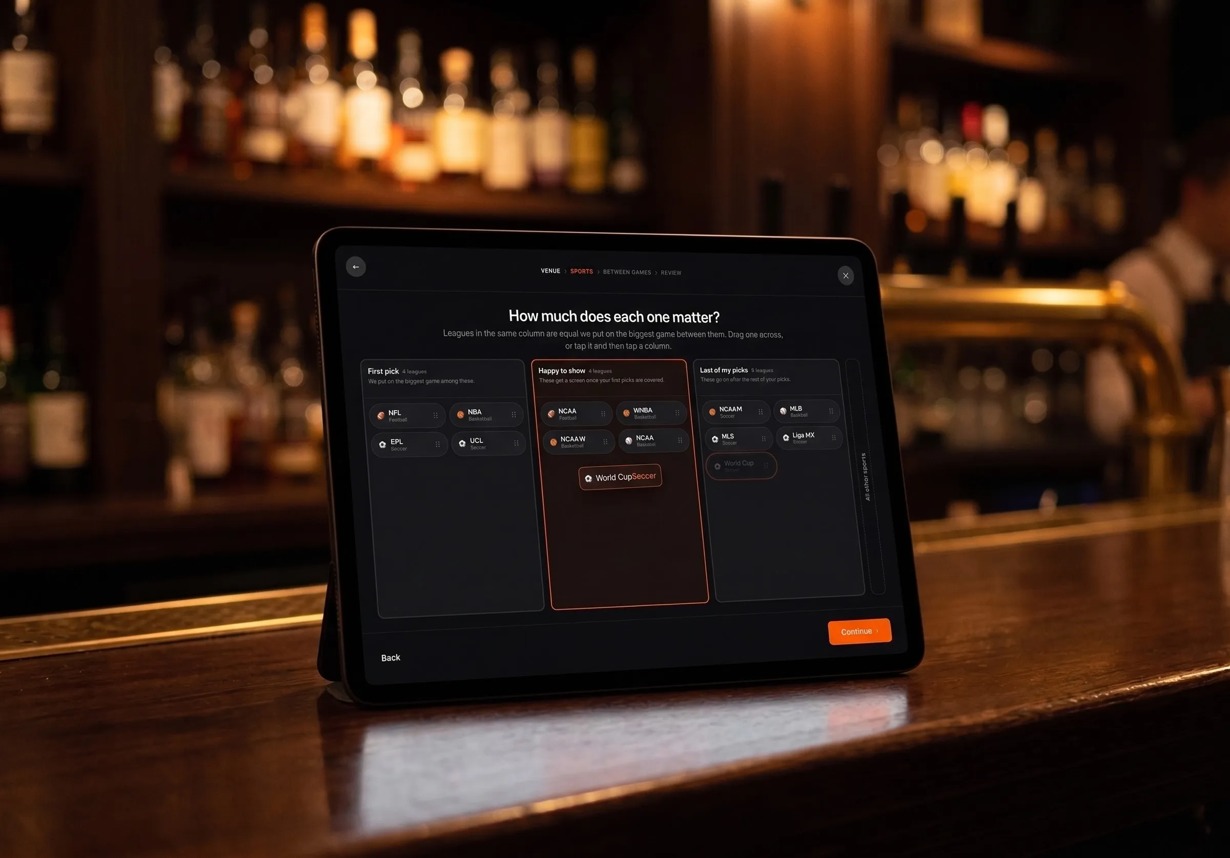 A tablet propped on a bar, showing a screen headed How much does each one matter, with leagues sorted across three columns from first pick to last.